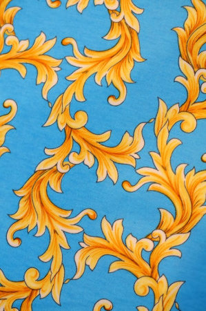 Трикотаж  ЗОЛОТЫЕ ЗАВИТКИ на голубом фоне